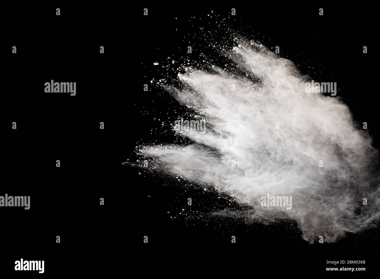 White powder explosion isolated on black background.White dust ...