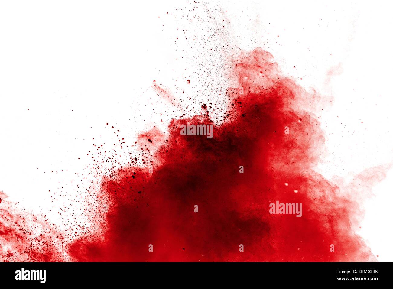 Red powder explosion on white background. Freeze motion of red dust particles splash. Stock Photo
