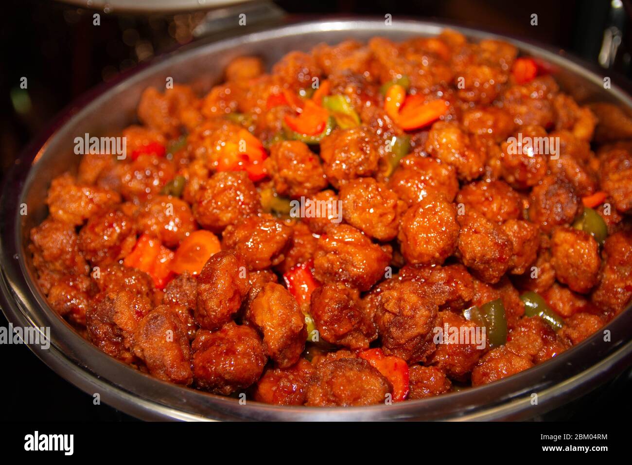 Large bowl of meatball sauce on a buffet tray. Stock Photo