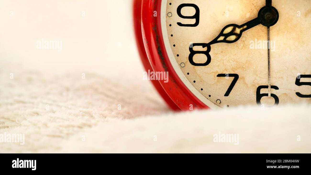 Time management concept - details of old retro red alarm clock ...
