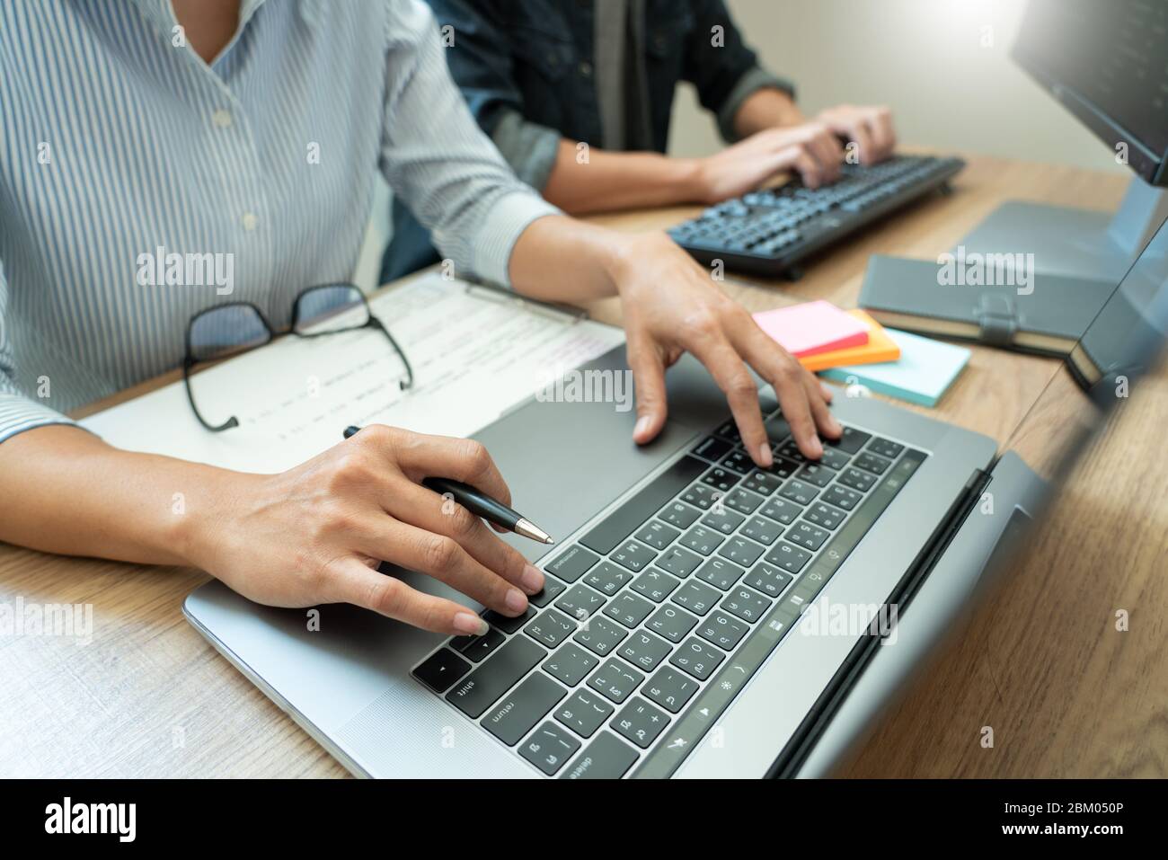 Collaborative work Software engineers website developer technologies or programmer working coding on startup ai application project on screen with par Stock Photo