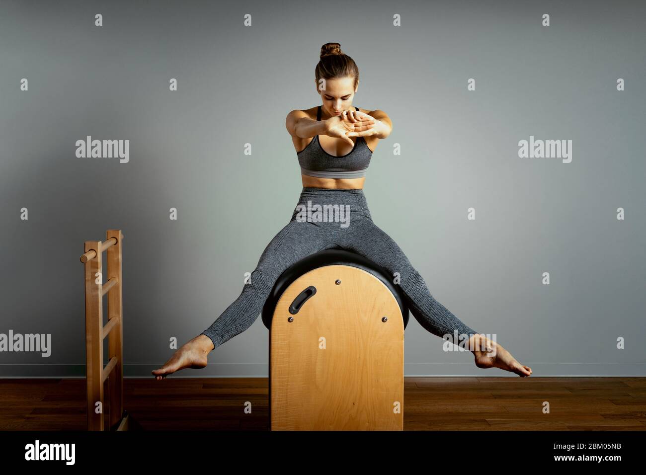 Pilates trainer exercises on a pilates barrel. Body training, perfect body  shape and posture correction opporno motor apparatus. Copy space Stock  Photo - Alamy