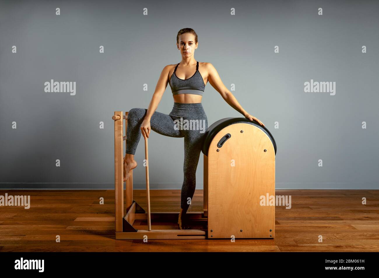Pilates trainer exercises on a pilates barrel. Body training