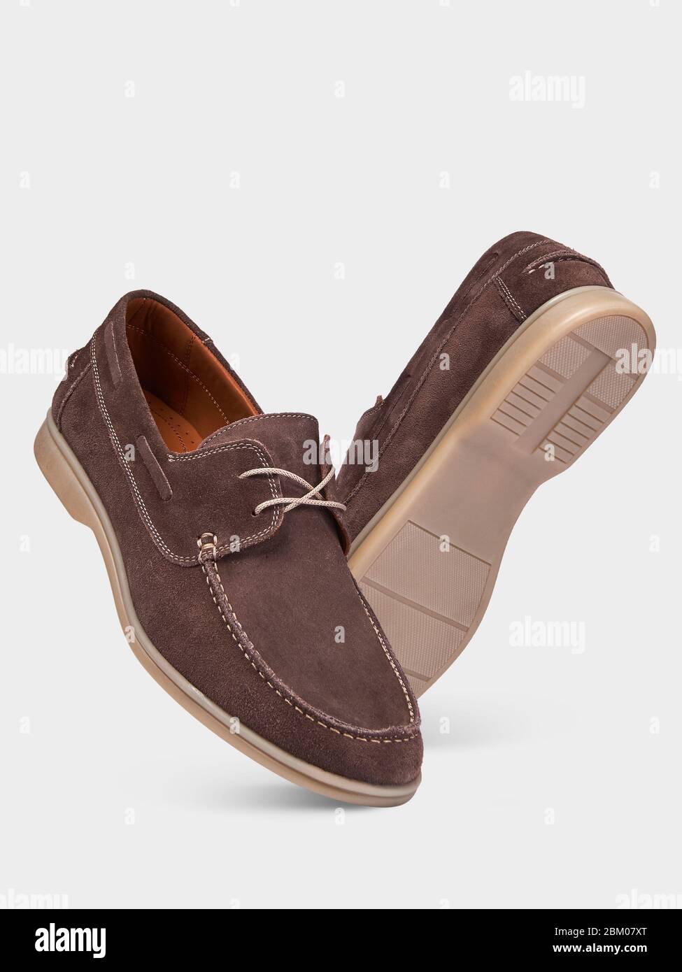 Men's summer suede brown loafers with laces and beige soles. isolated on a white background.Summer men's style. Men's classic style. Stock Photo