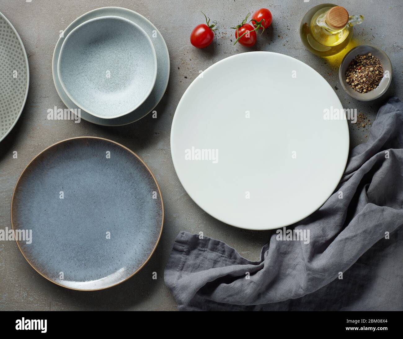 various empty plates on grey table, top view Stock Photo