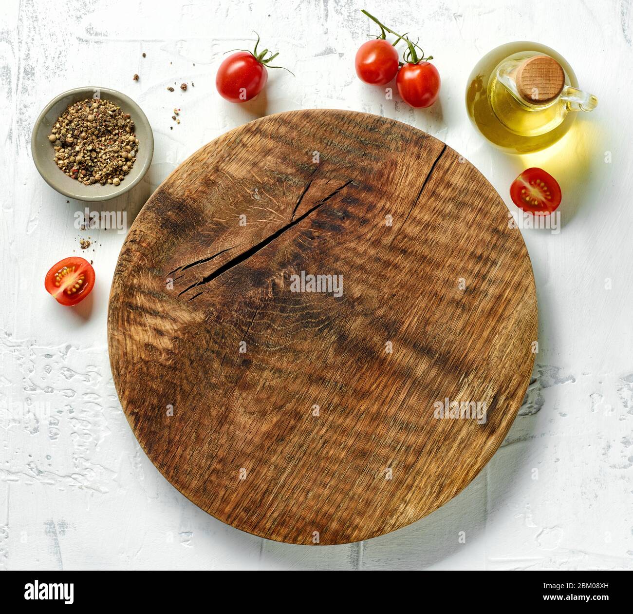 empty round wooden cutting board on white table, top view Stock Photo