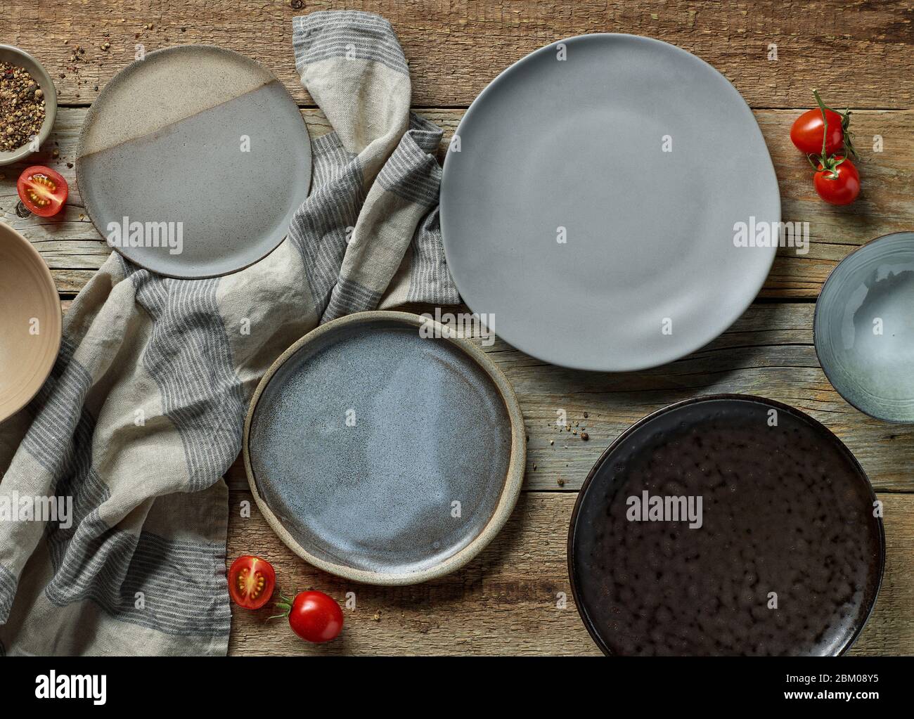 various empty plates on rustic wooden table, top view Stock Photo