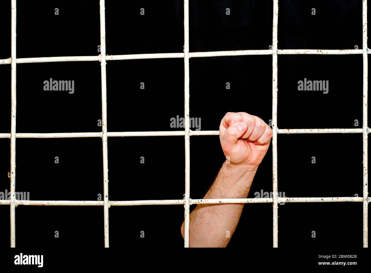 concept of limitation in the era of the quarantine pandemic human hand hold on to the iron bars Stock Photo