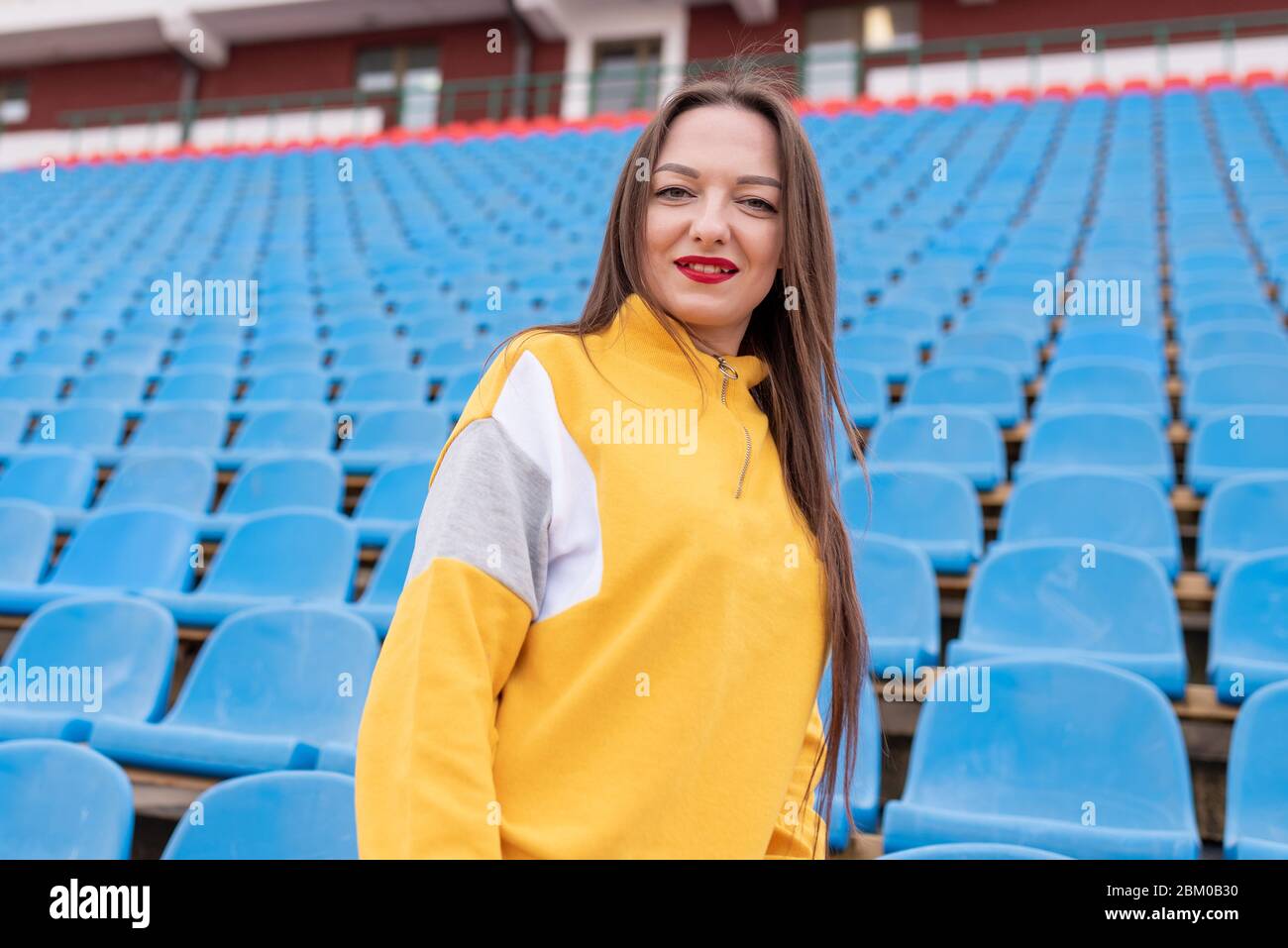 Girl alone in an empty stadium.  Stock Photo