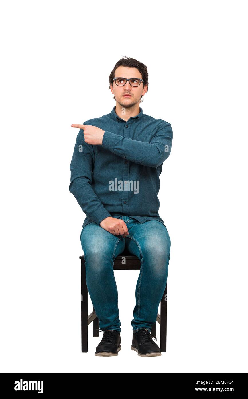 Full length of fink guy informer pointing index finger aside, blaming someone as guilty or choosing something, isolated on white background. Frustrate Stock Photo