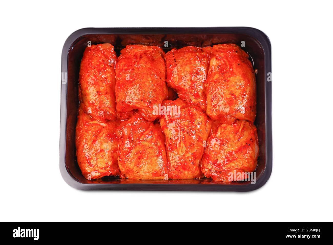 Vacuum packaging.Chicken legs in red marinade in plastic packaging for