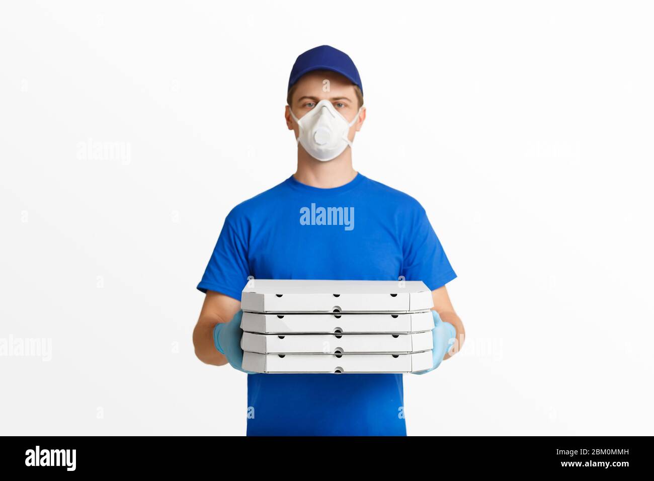 Courier with pizza in blue uniform isolated on white background Stock Photo