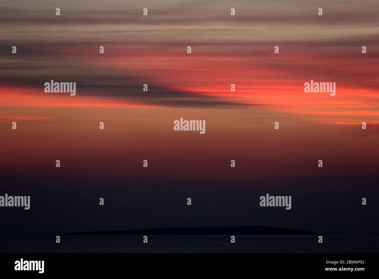 Apstract red blurry clouds on a dark sky during sunset Stock Photo