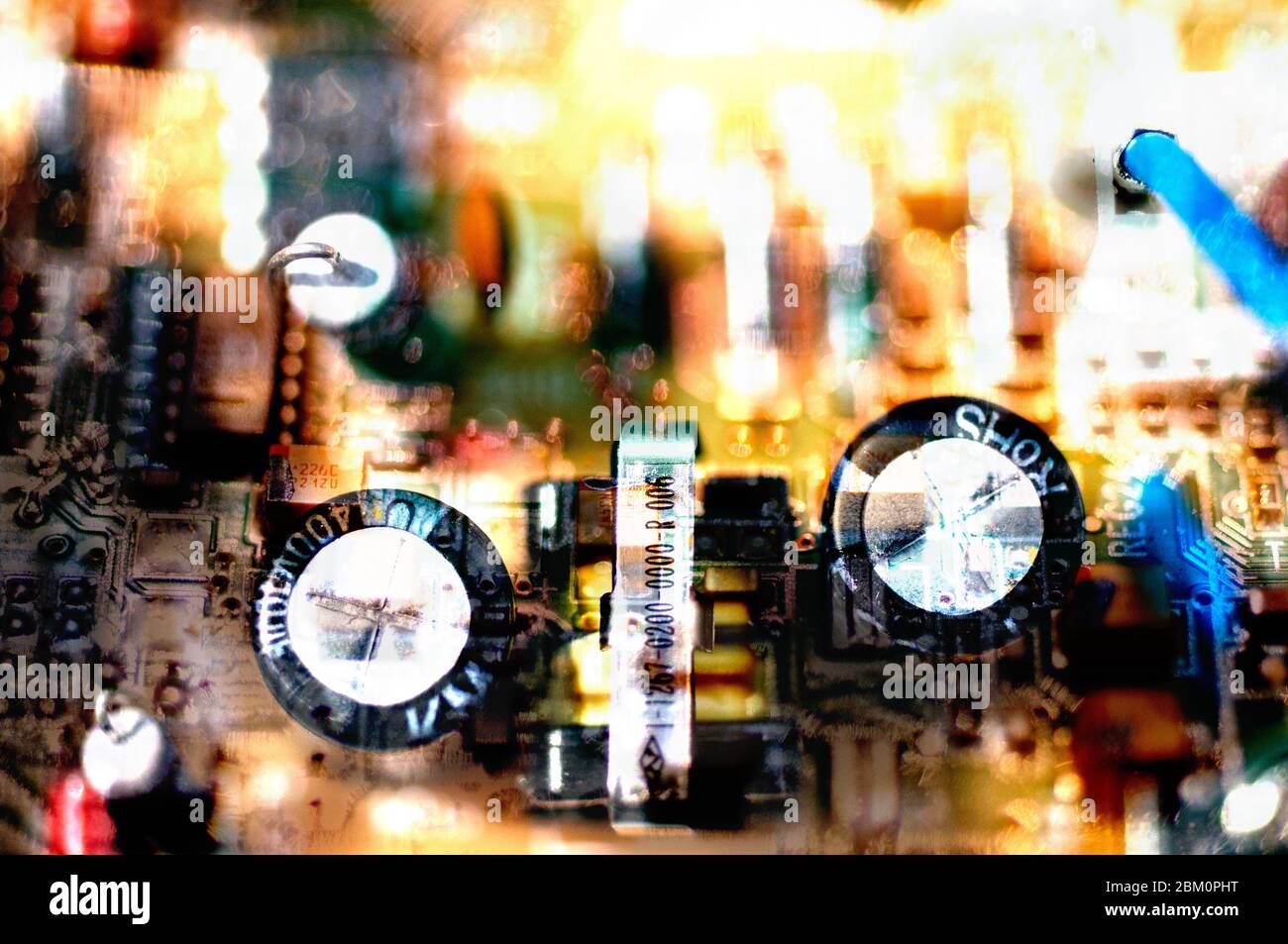 A montage of two photos of computer circuit boards blended together ...