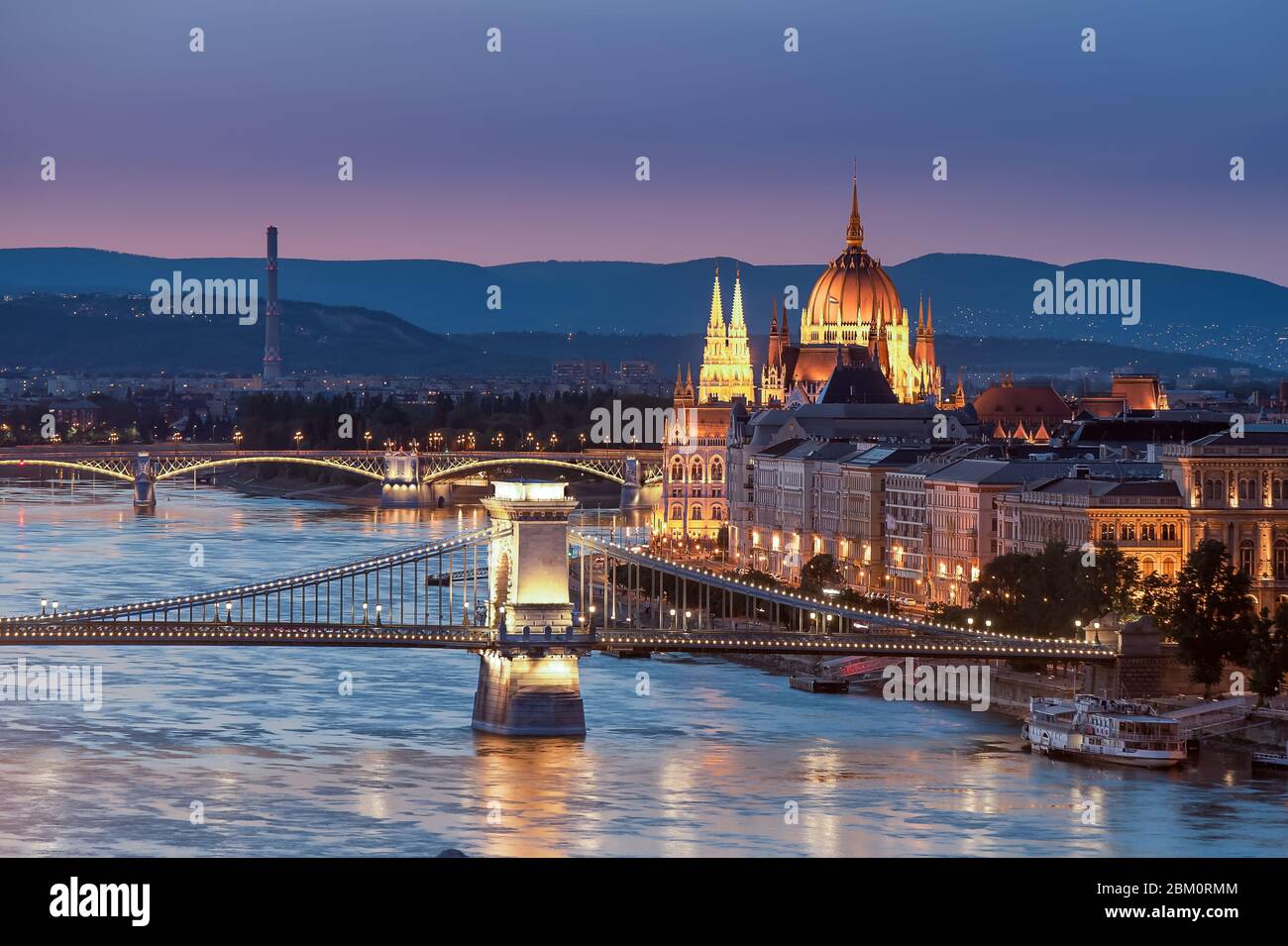 Hungary Budapest. Amazing photo about the Chain bridge and Danube river with Margaret bridge and cupola of Hungarian parliament historical building in Stock Photo