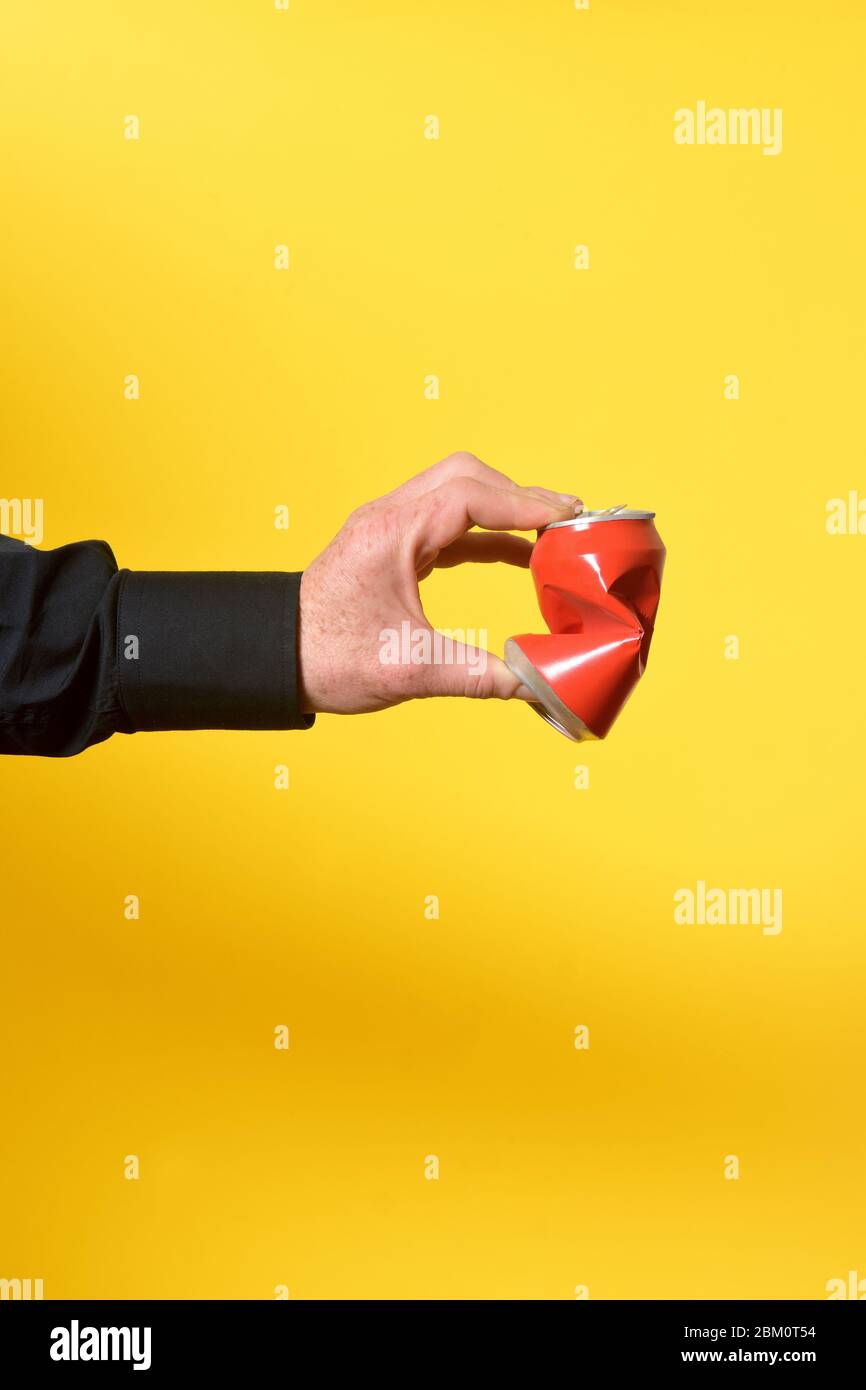 hand crushing a can of drink Stock Photo Alamy