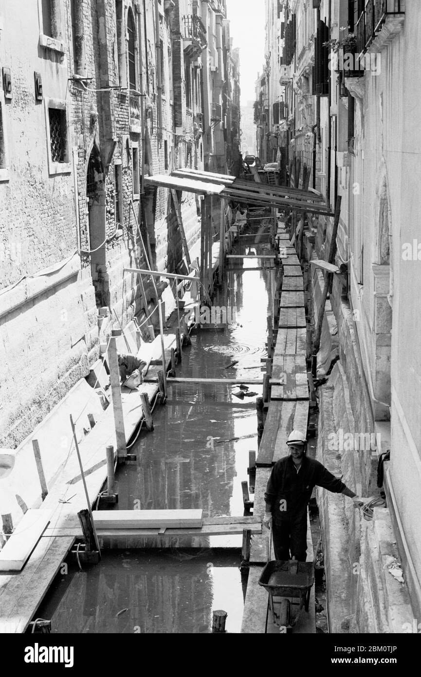VENICE ITALY WORKER IN A DRIED CANAL OF THE CITY - VENEZIA ITALIA - ITALIAN WORKER- SILVER FILM © Frédéric BEAUMONT Stock Photo