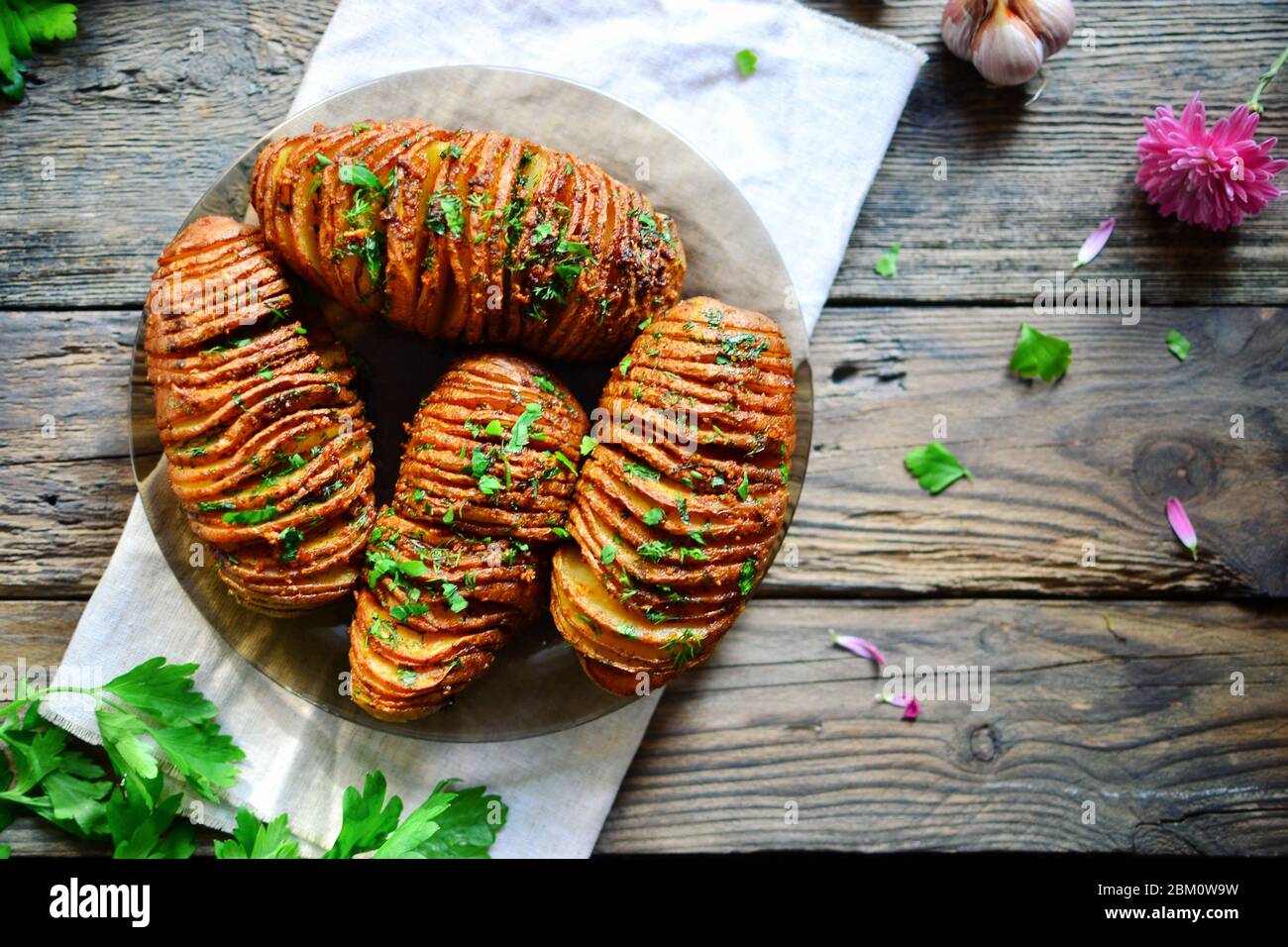 Hasselback potatoes. Appetizing potato accordion baked in the oven. Top
