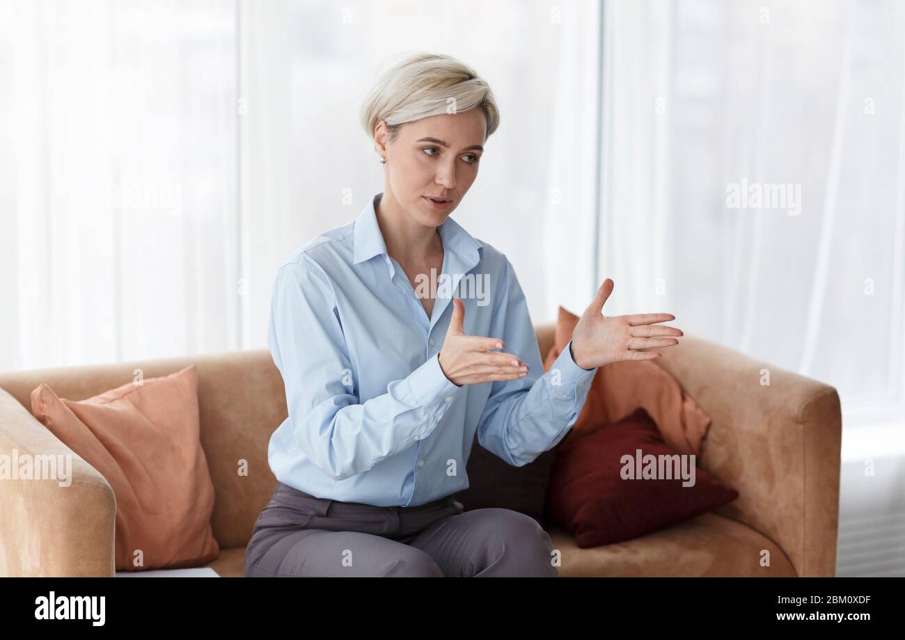 Professional Psychologist Giving Advice During Therapy Session Sitting