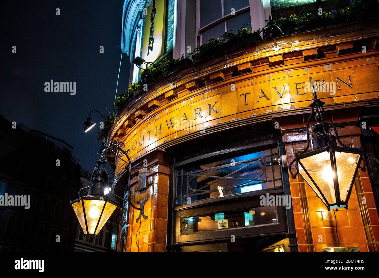 Exterior of Southwark Tavern pub at night, London Bridge, London, UK Stock Photo