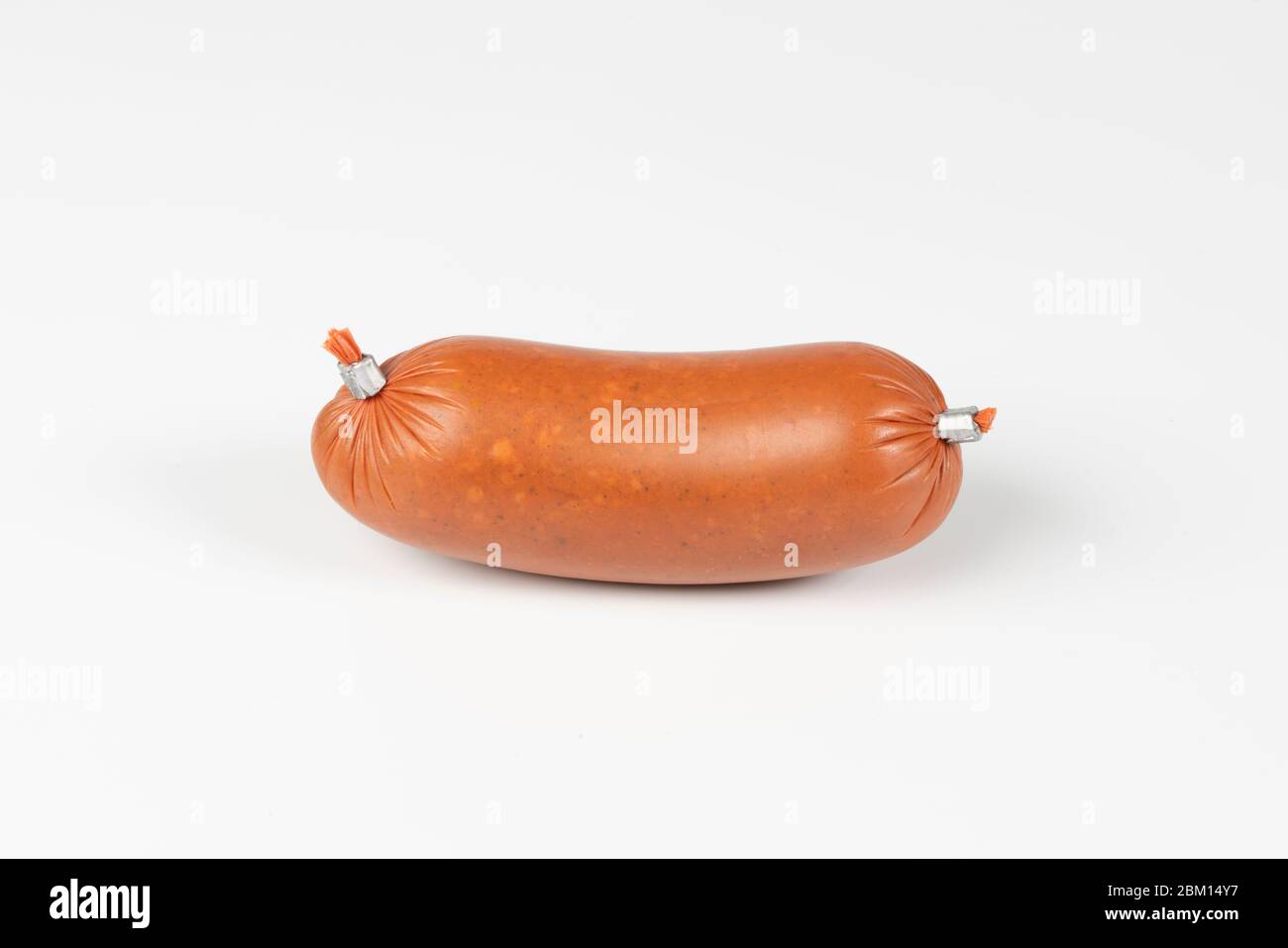 Smoked sausage in plastic shell isolated on white background. Top view Stock Photo