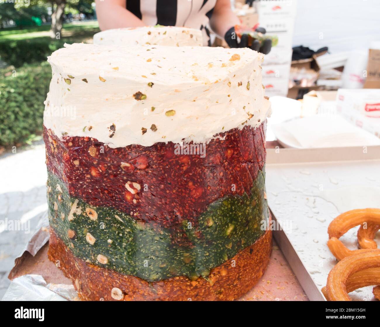 Cezerye, a semi-gelatinous traditional Turkish dessert made from caramelised carrots, shredded coconut, and roasted walnuts, hazelnuts, or pistachios. Stock Photo
