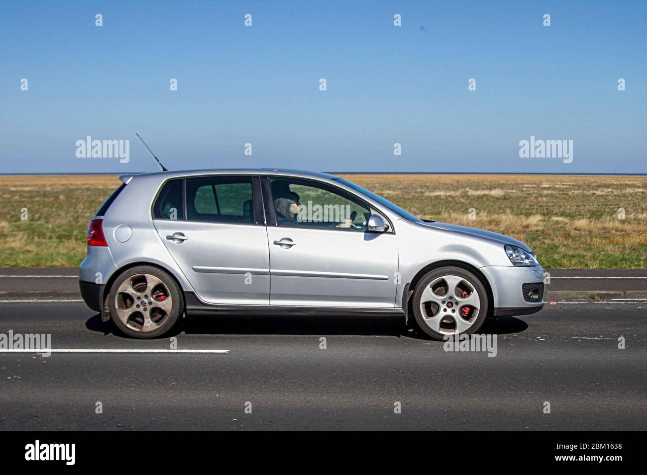 2007 silver Volkswagen Golf GTI Auto; Vehicular traffic moving vehicles, driving vehicle on UK roads, motors, motoring on the Southport coast road, UK Stock Photo