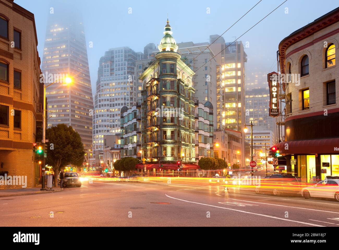 San Francisco, California, United States - Light trails at Columbus Avenue with Sentinel building and Transamerica Pyramid Building. Stock Photo