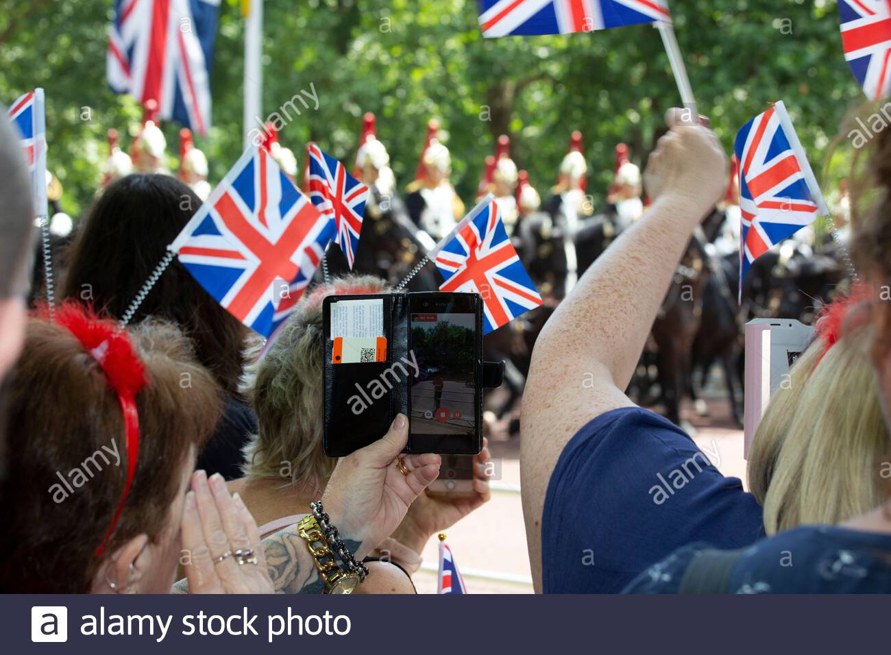 The annual Trooping the Colour has taken place in London in honour of Queen Elizabeth's birthday. Thousands lined the streets to welcome Her Majesty a Stock Photo