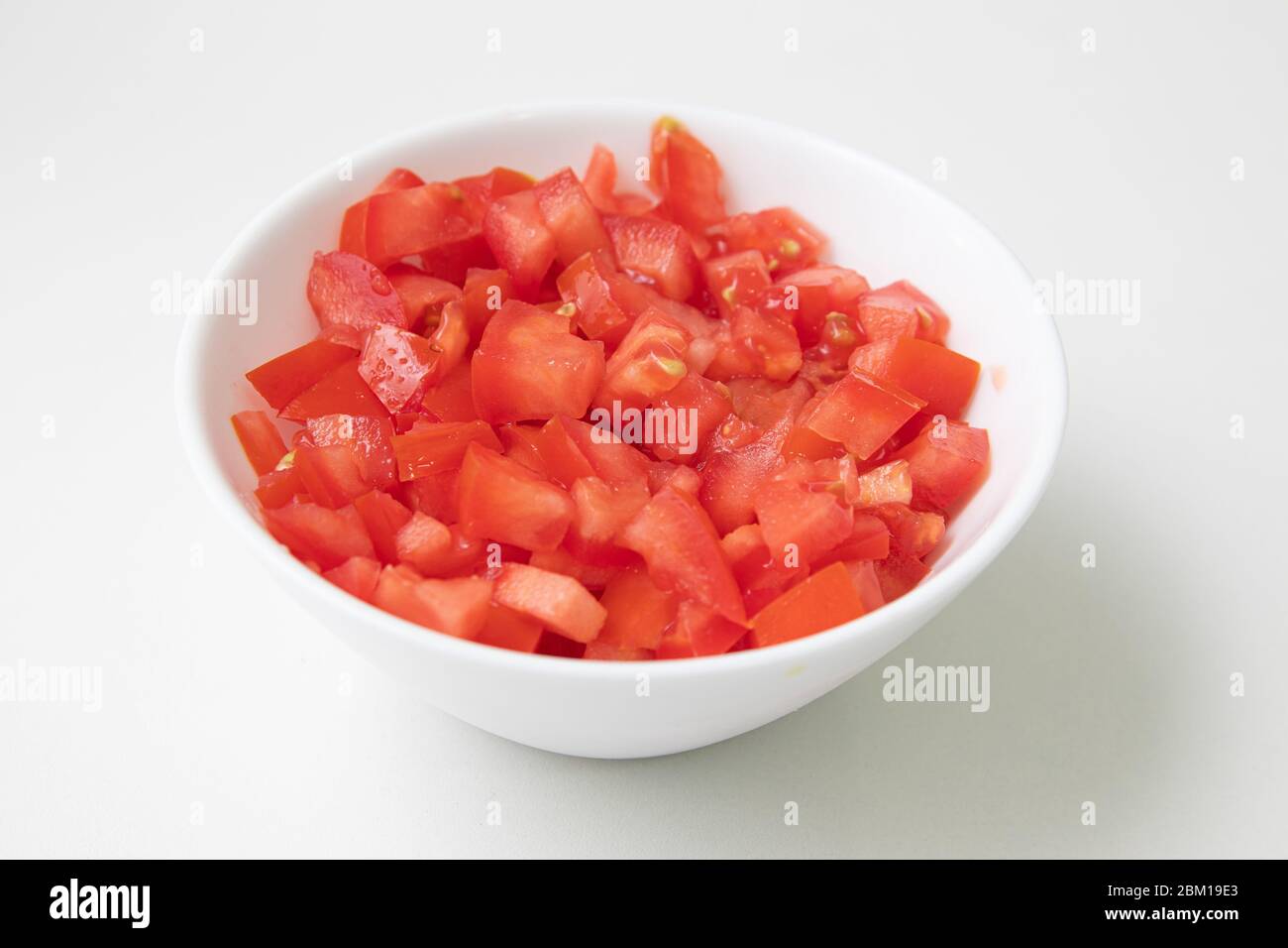 Chopped or Diced Tomatoes in a bowl isolated Stock Photo Alamy