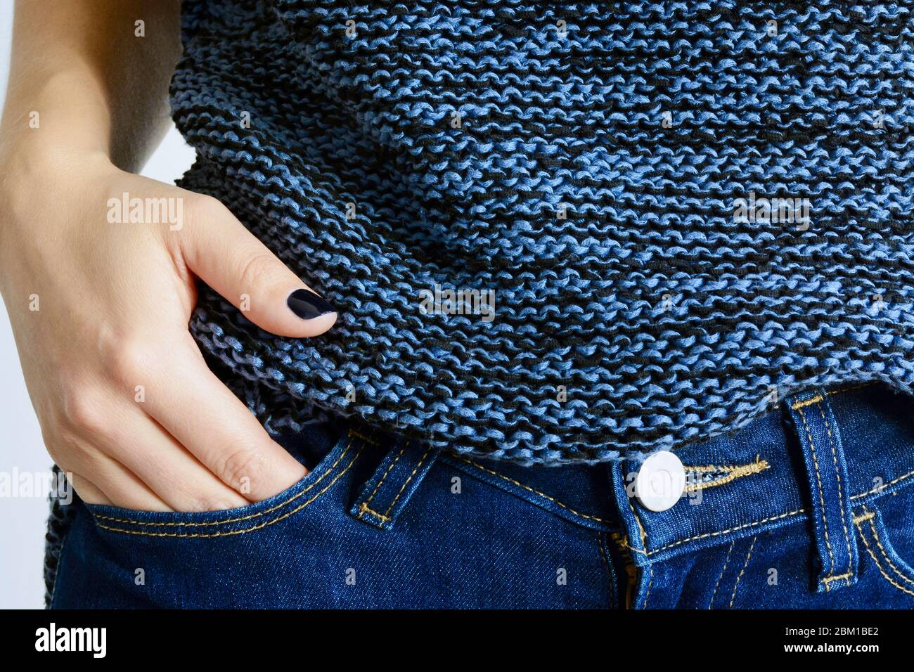 Classic Blue hue tone color. Woman wearing blue jeans, sweater and nail polish Stock Photo