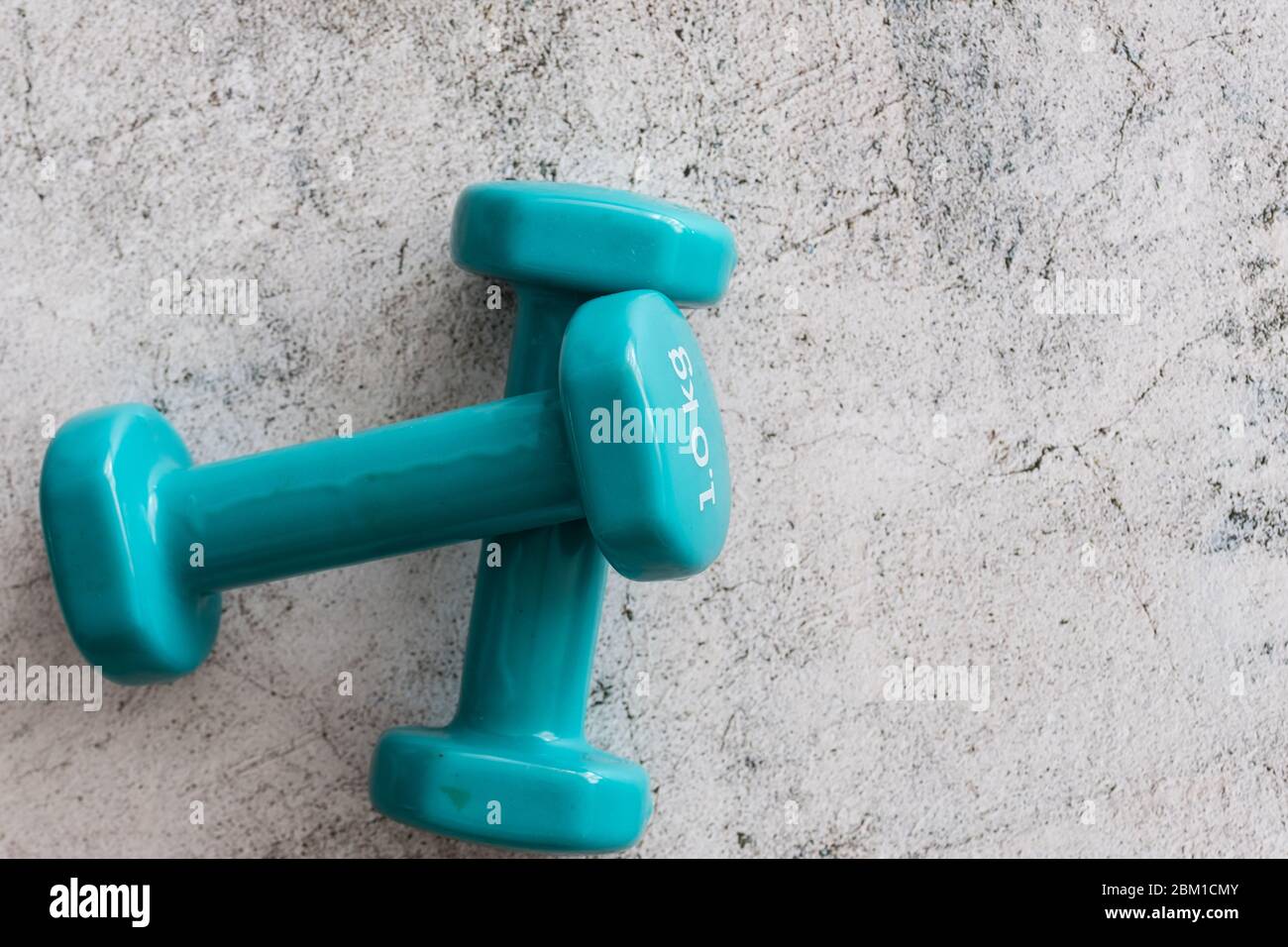 Two blue dumbbells isolated on white background Stock Photo