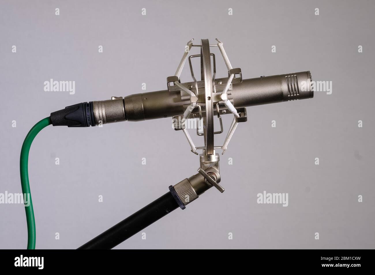 Small diaphragm condenser microphone in shock mount Stock Photo