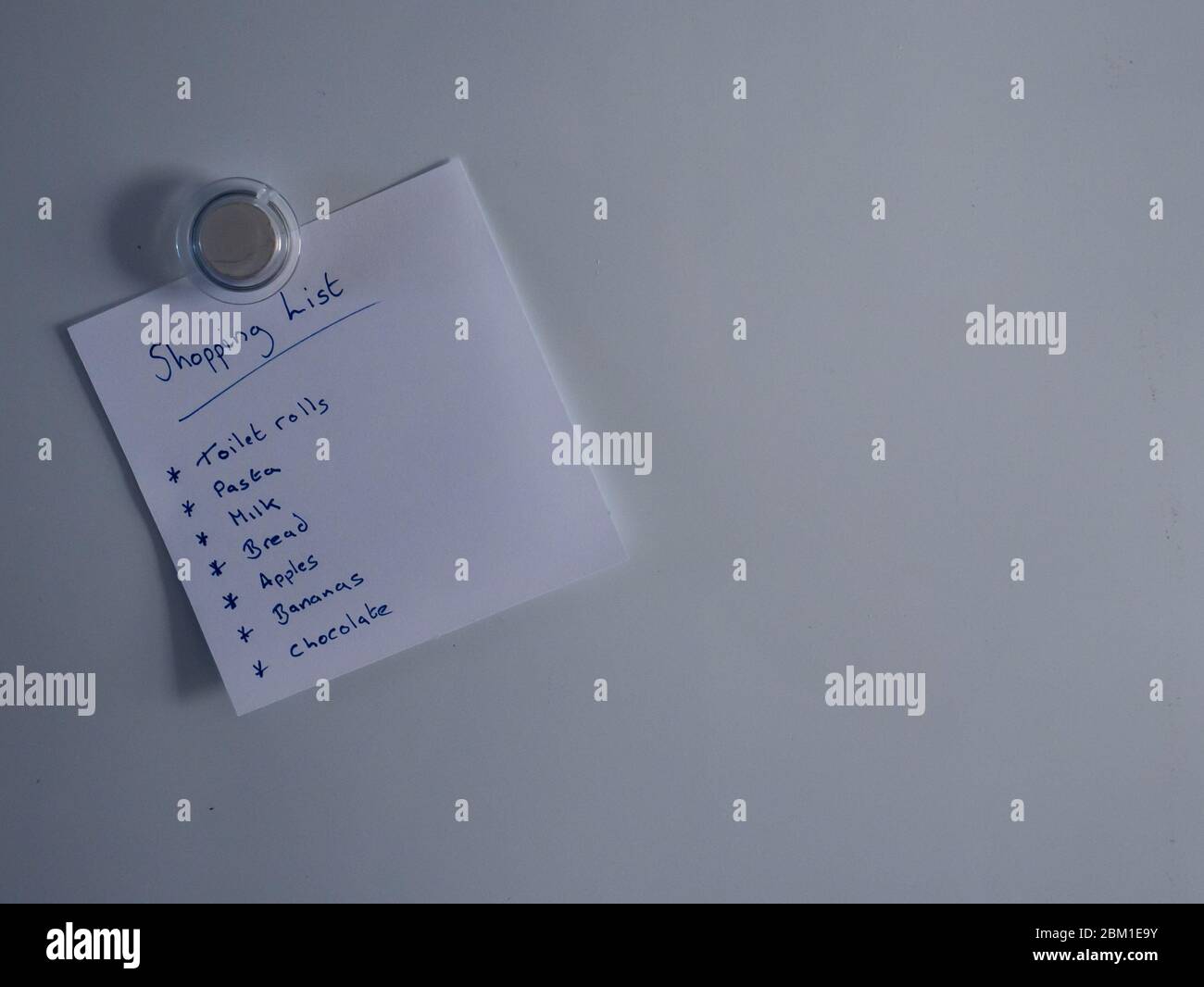 Shopping list on fridge door Stock Photo