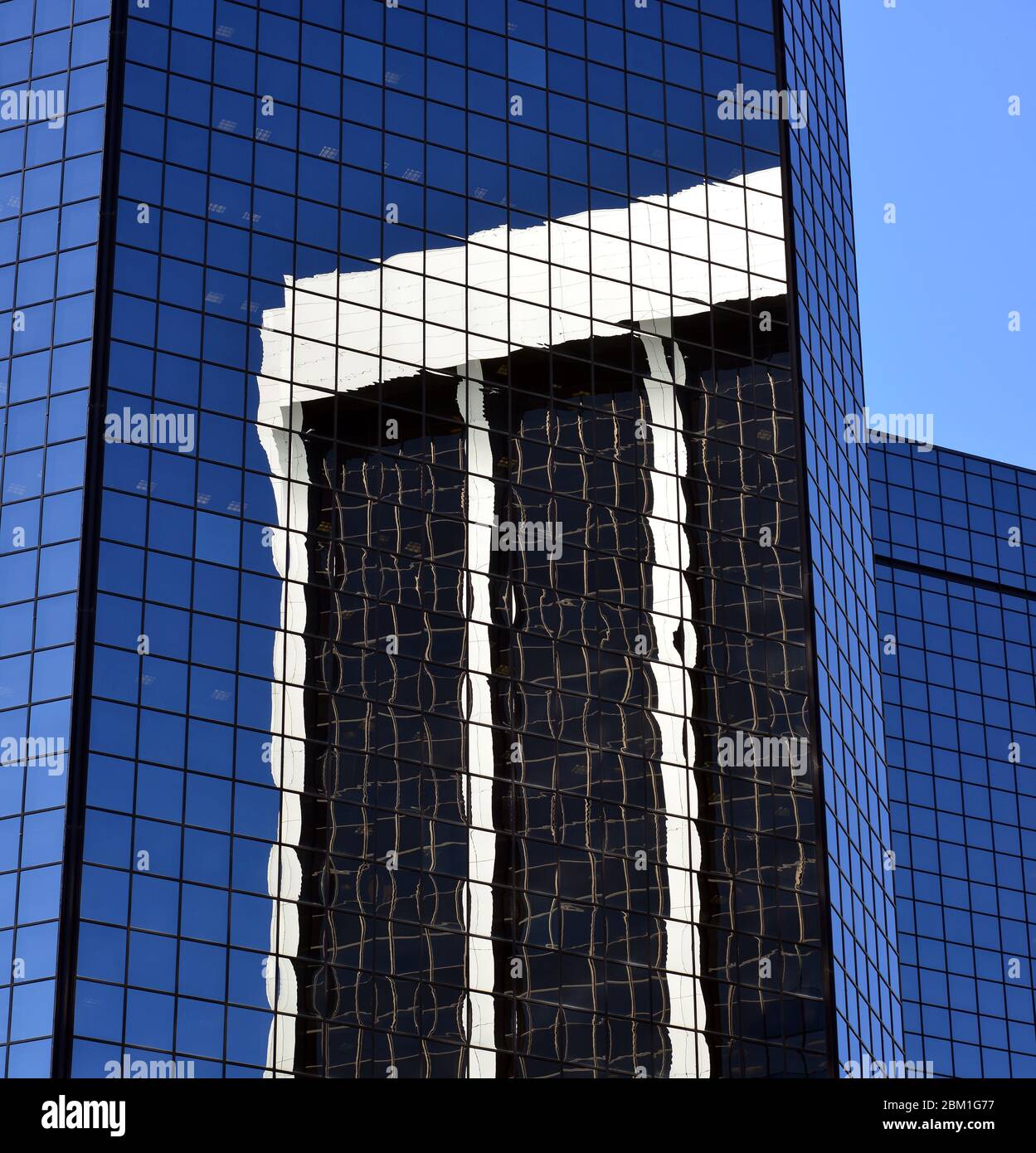 One skyscraper reflected in another on a sunny day in June, Denver, Colorado Stock Photo