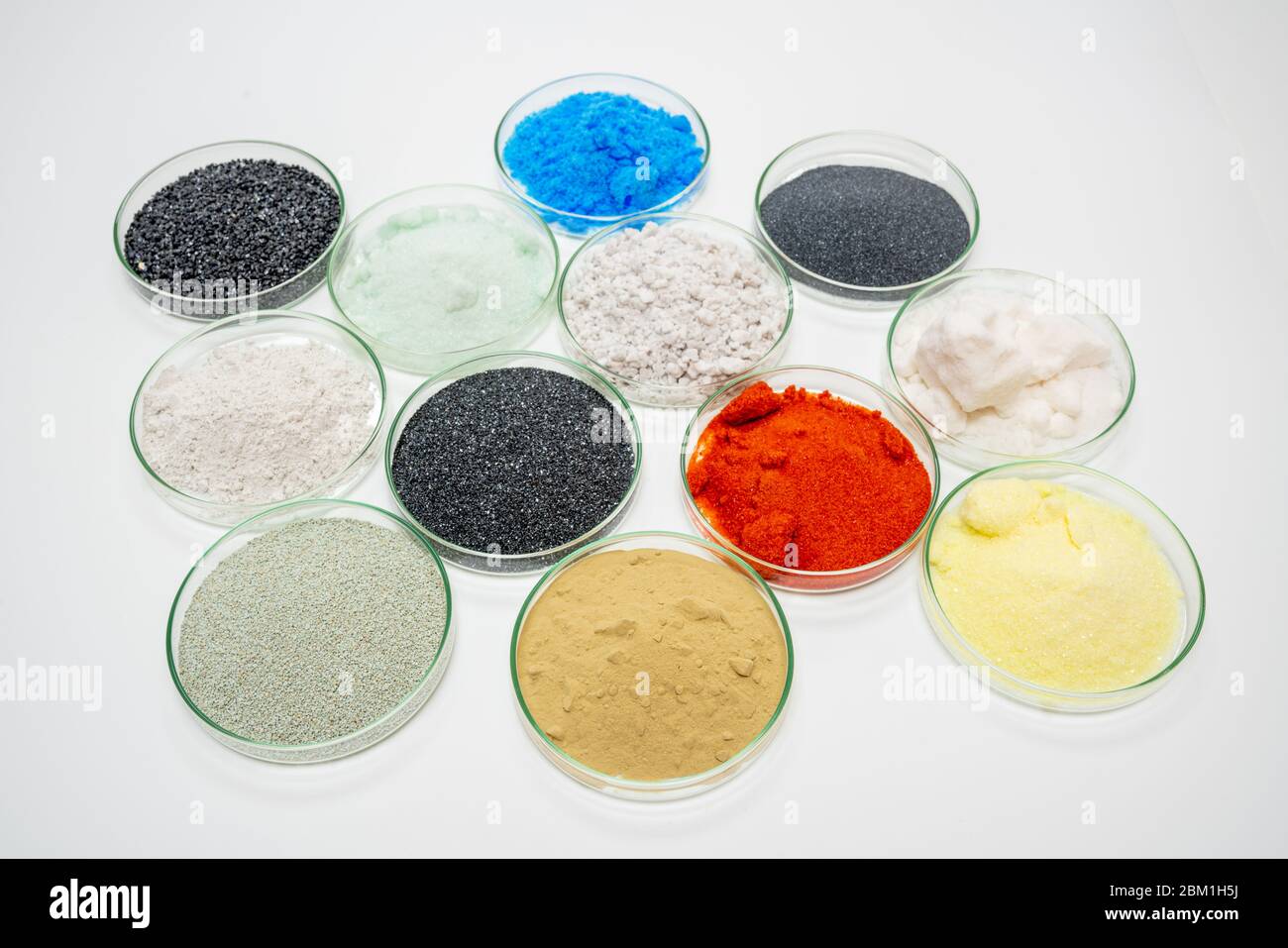 Examples of dry bulk chemical elements in petri dishes on a white