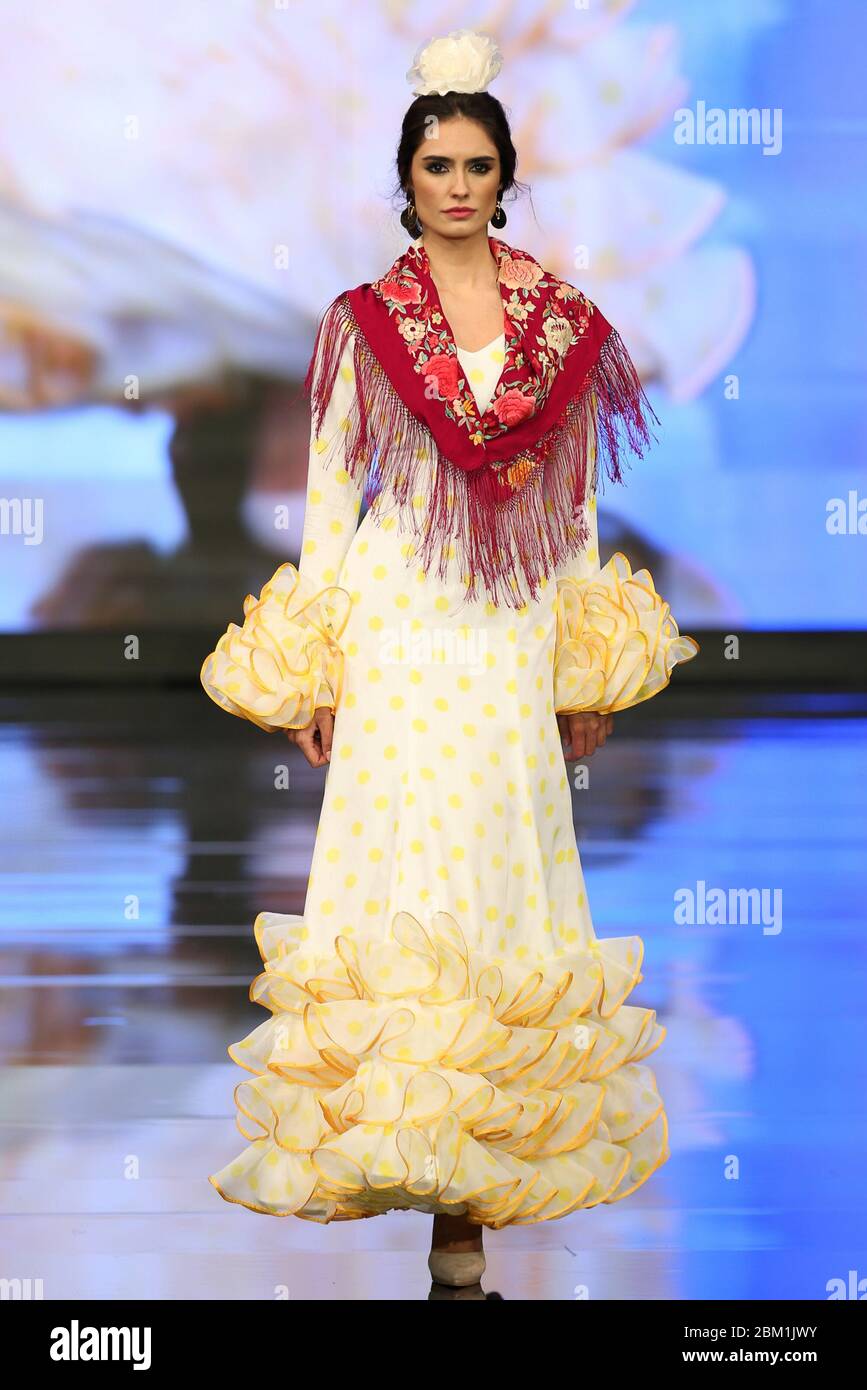 SEVILLA, SPAIN - JAN 30: Model wearing a dress from the Bajo el Soul de Andalucia collection by designer Miabril as part of the SIMOF 2020 (Photo credit: Mickael Chavet) Stock Photo