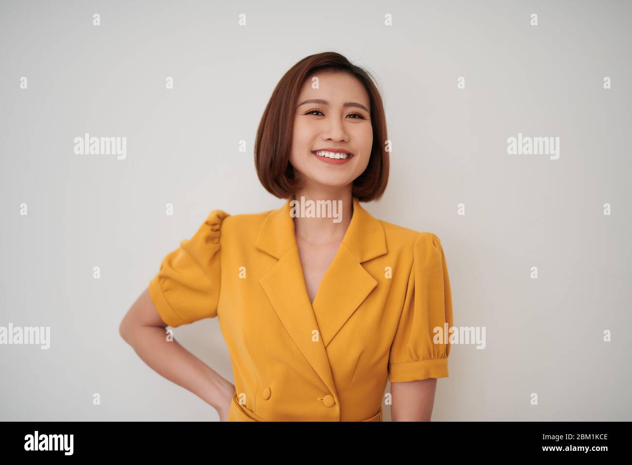 beautiful young woman against white wall Stock Photo - Alamy