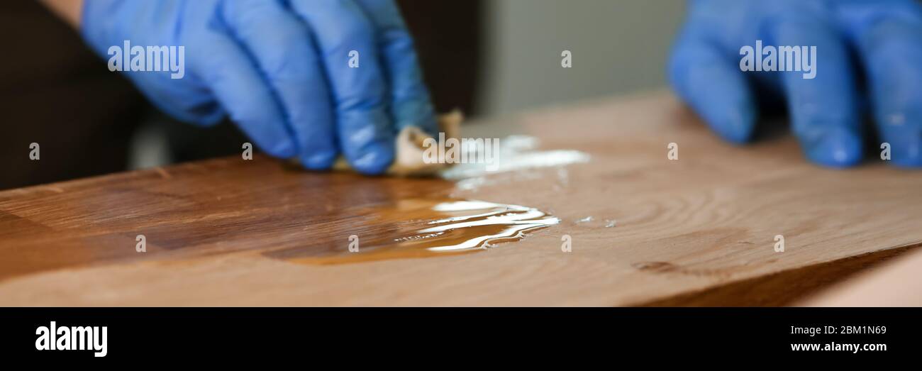 Man varnishing table at Stock Photo Alamy