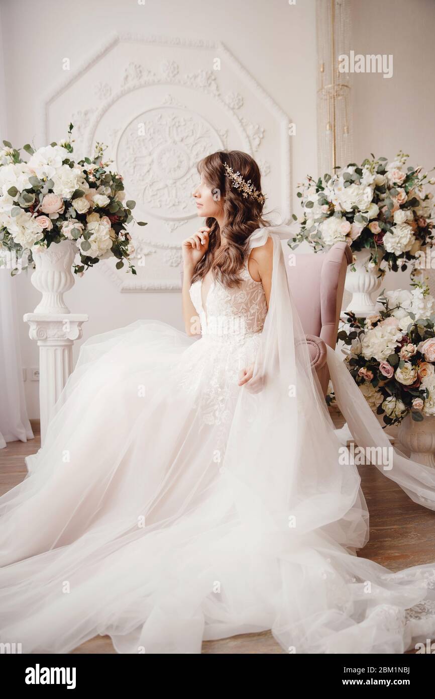 Beautiful young woman in white wedding dress smiling Stock Photo - Alamy