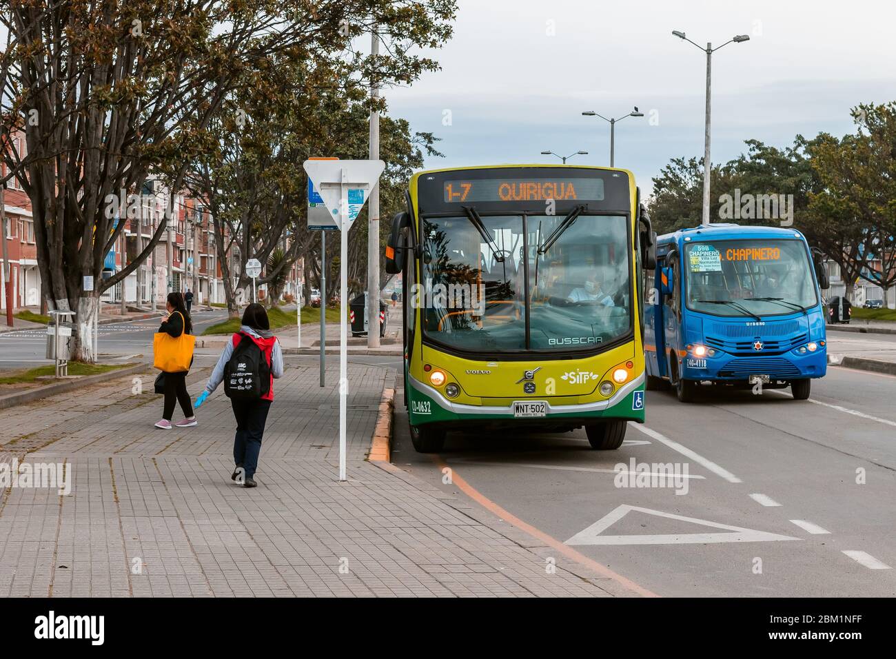 Feeder buses of the Bogotá mass transit system at a bus stop, Bogotá Colombia May 6, 2020 Stock