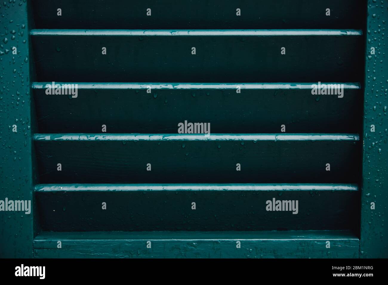 Green window shutters wooden dark vintage, blocking sunlight Stock