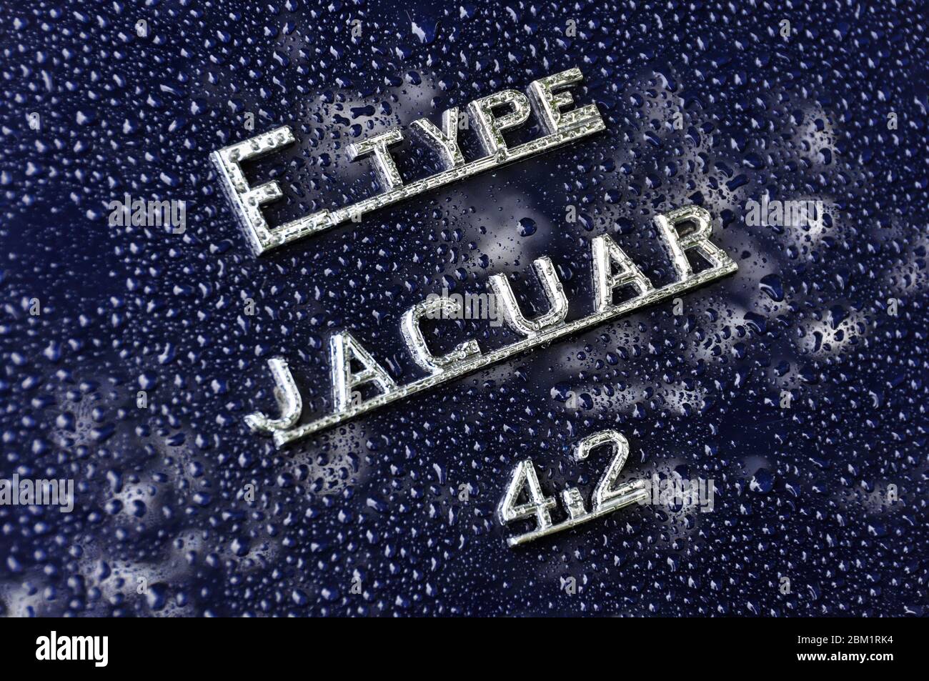 Raindrops on Jaguar E-Type 4.2 sign Stock Photo