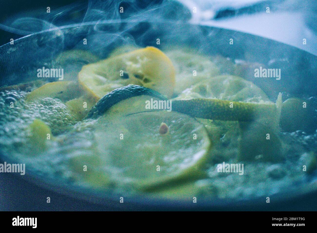 boiling lemon, limes, orange and pineapples for tea Stock Photo Alamy