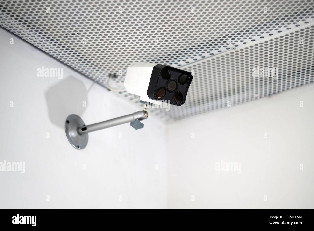 CCTV camera are installed on the wall. Security cam is in white interior background. Stock Photo