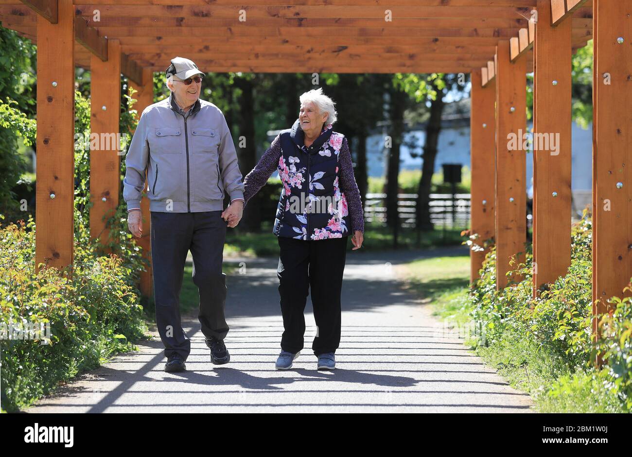 Pat and Josephine Barrett enjoy a stroll in the Rose Garden at St Anne's Park, Dublin, as the coronavirus lockdown conditions continue. May 6, 2020. See PA story HEALTH Coronavirus Ireland. Photo credit should read: Julien Behal/PA Wire Stock Photo