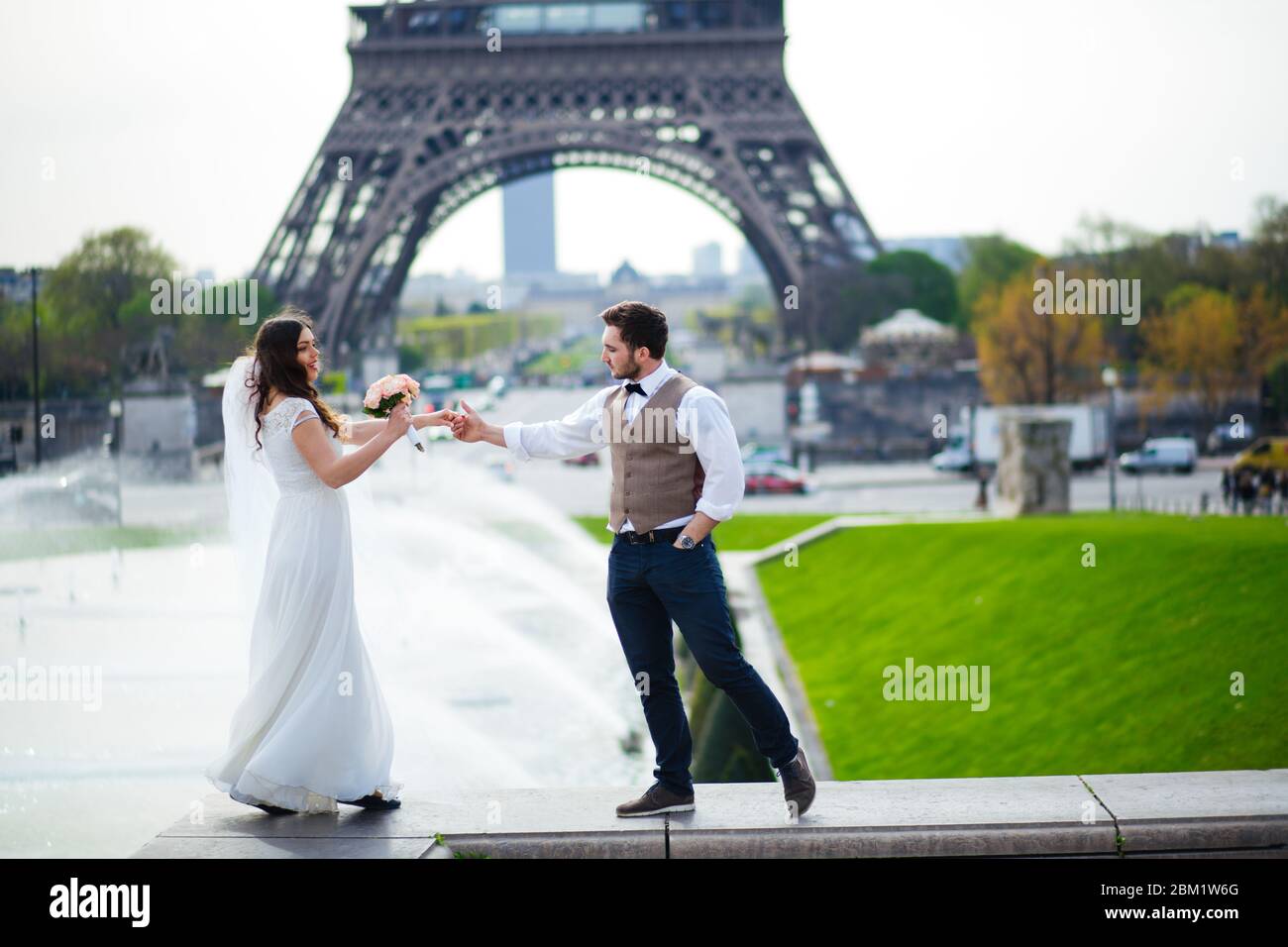 wedding couple. The bride in a beautiful wedding dress, the bride in a stylish tuxedo, Paris France. Stock Photo