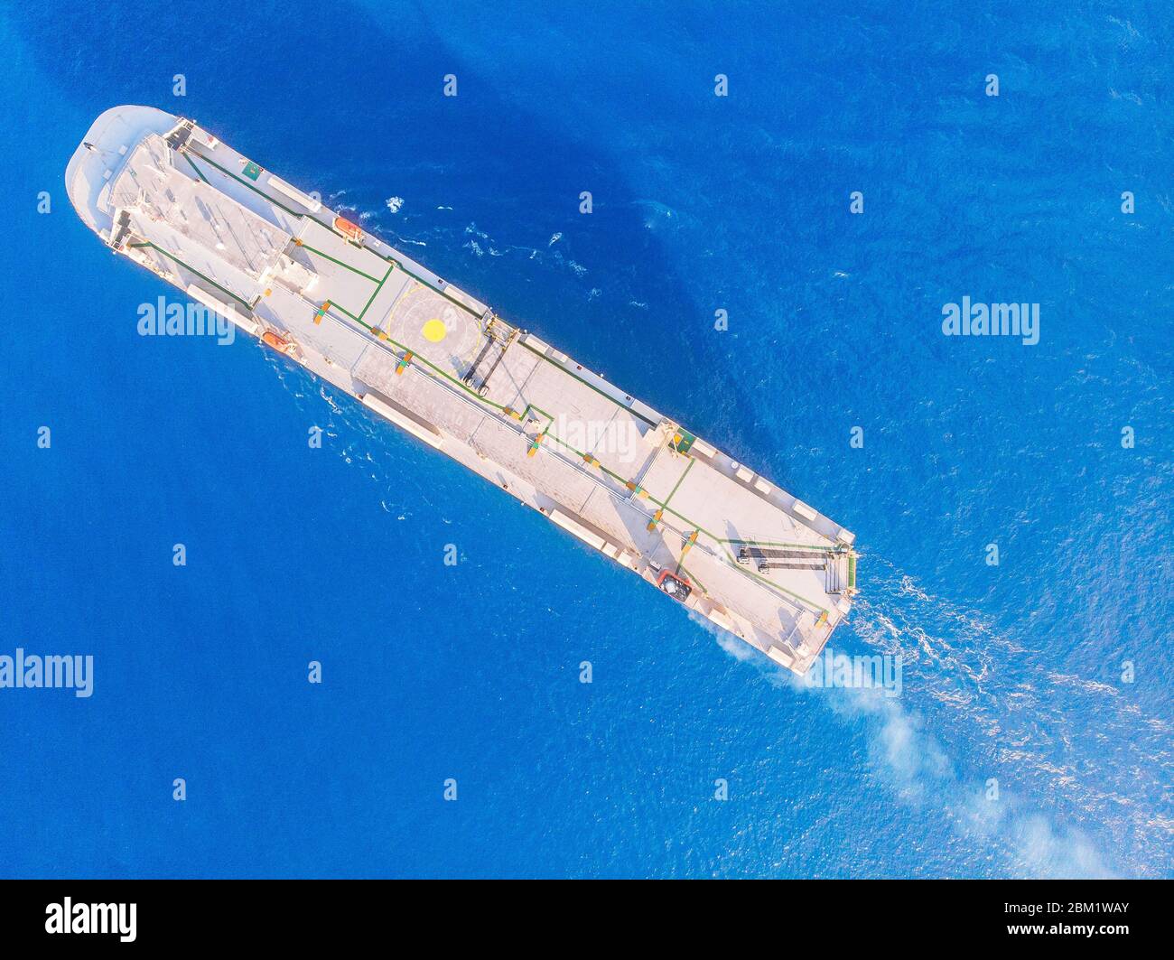 Car carrier shipping out trade port blue sea. Aerial top view Stock