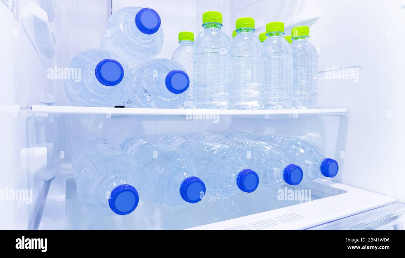 many mineral fresh and clean drinking water in plastic bottle freeze in  cooler shelf or refrigerator in kitchen for cool water for people Stock  Photo - Alamy