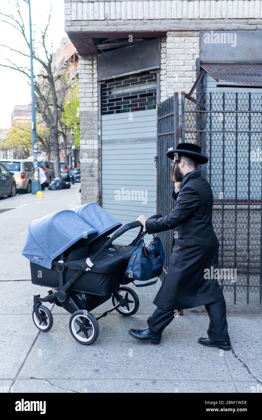 New York, USA - May 3 2020: Hasidic Jews in Williamsburg Brooklyn in the Park and on Streets in Groups and Alone with Children During Coronavirus COVI Stock Photo